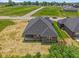 Aerial view of the property showcasing surrounding green space, neighboring homes, and a quiet street at 2184 Galleone Way, Plainfield, IN 46168