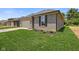 View of home's garage and landscaping featuring healthy green lawn and gray brick at 2184 Galleone Way, Plainfield, IN 46168