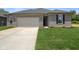 Inviting home with green lawn, concrete driveway, and a two-car garage providing ample parking at 2184 Galleone Way, Plainfield, IN 46168