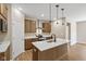 Well-lit kitchen showcasing wooden cabinets, stainless steel appliances, and an island with a sink and white countertop at 2184 Galleone Way, Plainfield, IN 46168