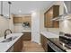 Stylish kitchen featuring wood cabinetry, white countertops, and stainless steel appliances at 2184 Galleone Way, Plainfield, IN 46168