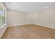 Well-lit living room with wood-look floors, neutral walls, and a large window at 2184 Galleone Way, Plainfield, IN 46168