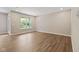 Spacious living room with wood-look flooring and a bright window, providing ample natural light at 2184 Galleone Way, Plainfield, IN 46168