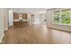 Open living space with wood-look floors, a kitchen island, and plenty of natural light at 2184 Galleone Way, Plainfield, IN 46168