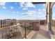 Outdoor balcony with decorative metal railing overlooks the community, cityscape, and blue sky at 1155 S Rangeline Rd # 504, Carmel, IN 46032