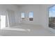 Unfinished bedroom with closet, two windows providing lots of light, and balcony access, ready for design and decor at 1155 S Rangeline Rd # 504, Carmel, IN 46032
