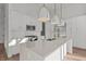 Bright kitchen with stainless appliances, a subway tile backsplash, and an island with quartz countertop at 1155 S Rangeline Rd # 504, Carmel, IN 46032