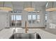 Modern kitchen featuring quartz counters, stainless steel sink, gold faucet and oversized pendant lighting at 1155 S Rangeline Rd # 504, Carmel, IN 46032