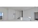 Bright, unfinished living space with high ceilings, large windows, and a private balcony entrance, ready for customization at 1155 S Rangeline Rd # 504, Carmel, IN 46032