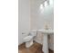 Stylish powder room with decorative tile accent wall, vessel sink, and modern gold faucet at 1155 S Rangeline Rd # 504, Carmel, IN 46032