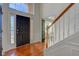 Bright and airy entryway with hardwood floors, a black door, and elegant staircase at 12106 Cabri Ln, Fishers, IN 46037