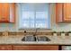 Modern kitchen sink with granite countertops and wood cabinets at 12106 Cabri Ln, Fishers, IN 46037