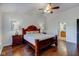 Main bedroom with hardwood floors, large bed, and en-suite bathroom at 12106 Cabri Ln, Fishers, IN 46037