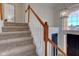 Stairs with wood railing leading to upper level at 12106 Cabri Ln, Fishers, IN 46037