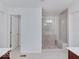 Bright bathroom with dual vanities, a glass shower, and a doorway leading to another room at 2898 Creekridge Ct, Columbus, IN 47201