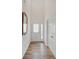Bright entryway features wood-look flooring, decorative mirror, and access to coat closet at 2898 Creekridge Ct, Columbus, IN 47201