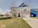 Charming two-story home with stone accents, landscaped yard, and attached two car garage at 2898 Creekridge Ct, Columbus, IN 47201