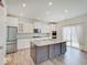 Modern kitchen featuring a large island, stainless steel appliances, and stone countertops at 2898 Creekridge Ct, Columbus, IN 47201