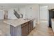 Kitchen island with stainless steel appliances, hardwood floors, and white cabinetry at 2898 Creekridge Ct, Columbus, IN 47201