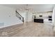 Open-concept living room with hardwood floors, staircase, and chandelier, flowing into the kitchen at 2898 Creekridge Ct, Columbus, IN 47201