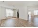 Spacious living room features hardwood floors, large windows, and an elegant chandelier at 2898 Creekridge Ct, Columbus, IN 47201