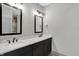 Bathroom featuring double vanity, marble countertops, dark wood cabinets, and bronze fixtures at 82 E Wayne St # C, Franklin, IN 46131