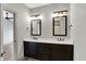 Bathroom with a double vanity featuring marble countertops and dark wood cabinets at 82 E Wayne St # C, Franklin, IN 46131