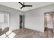 Bedroom featuring wood-look flooring, a ceiling fan, plus closet and bathroom access at 82 E Wayne St # C, Franklin, IN 46131