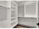 Walk-in closet with custom shelving and wood-look flooring at 82 E Wayne St # C, Franklin, IN 46131