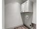 Well-lit laundry room with white cabinets and hardwood floors at 82 E Wayne St # C, Franklin, IN 46131