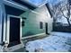 Rear exterior showing teal siding, black door, and patio at 2133 N Talbott St, Indianapolis, IN 46202