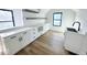 Modern white kitchen with quartz countertops and hardwood floors at 2133 N Talbott St, Indianapolis, IN 46202