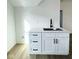 White kitchen island with quartz countertop and black faucet at 2133 N Talbott St, Indianapolis, IN 46202