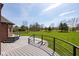 Open deck overlooking lush green lawns with stairs and metal railings at 4499 W 131St St, Carmel, IN 46074