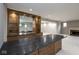 Basement with custom-built bar area, cabinets, granite counters, and a fireplace at 4499 W 131St St, Carmel, IN 46074