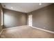 A carpeted room with gray walls, white trim, a white door and a window at 4499 W 131St St, Carmel, IN 46074