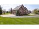 Beautiful brick home featuring a side-entry garage and manicured lawn at 4499 W 131St St, Carmel, IN 46074