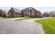 Elegant brick home with a grand entrance and manicured landscaping, offering curb appeal at 4499 W 131St St, Carmel, IN 46074