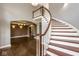 Elegant foyer showcasing a curved staircase and gleaming hardwood floors at 4499 W 131St St, Carmel, IN 46074