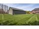 Side view of a gray garage and a well-manicured lawn at 4499 W 131St St, Carmel, IN 46074