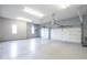 Well-lit garage with white doors and epoxy flooring, providing ample storage space at 4499 W 131St St, Carmel, IN 46074