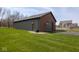 Detached garage with a gray door, brick accents, and a spacious lawn at 4499 W 131St St, Carmel, IN 46074