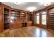 Spacious library offers ample shelving, hardwood floors, and natural light from large arched windows at 4499 W 131St St, Carmel, IN 46074
