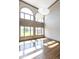 Bright living space showcasing high ceilings, large arched windows, and hardwood floors at 4499 W 131St St, Carmel, IN 46074