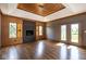 Bright living room boasts wood floors, modern fireplace, and access to the outdoors through French doors at 4499 W 131St St, Carmel, IN 46074