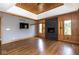 Elegant living room features a sleek fireplace, wood paneled walls, and hardwood floors at 4499 W 131St St, Carmel, IN 46074