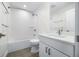 Compact bathroom featuring a bathtub, shower, and vanity with a modern countertop at 806 7Th St, Columbus, IN 47201