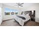 Inviting bedroom featuring a large window with a view, a queen bed, and a modern ceiling fan at 806 7Th St, Columbus, IN 47201
