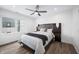 Bedroom featuring a large bed with stylish headboard and modern ceiling fan with a view of the outside at 806 7Th St, Columbus, IN 47201