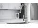 Contemporary kitchen faucet features a white countertop, stainless steel appliances and modern cabinetry at 806 7Th St, Columbus, IN 47201